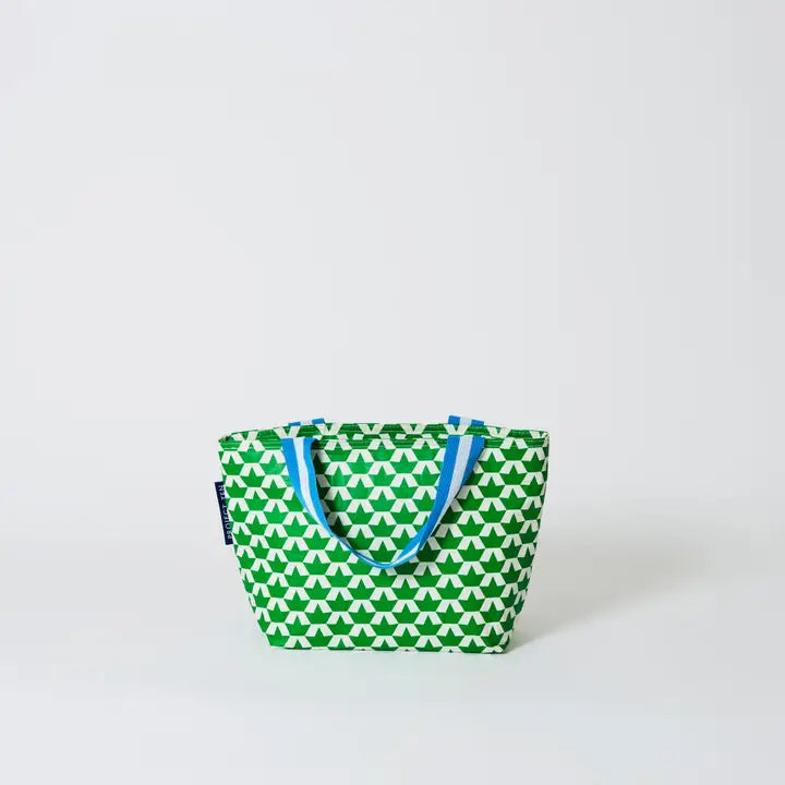 Green and white patterned tote bag with blue handles on a light gray background