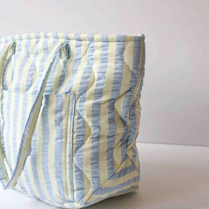 Striped bag with blue and yellow pattern on a white background
