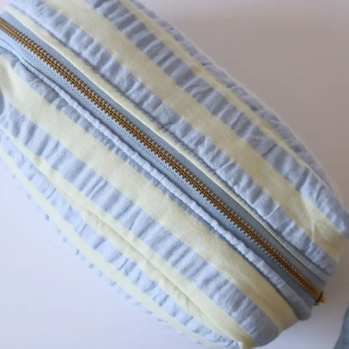 Close-up of a fabric with a zipper, showing texture and color details.