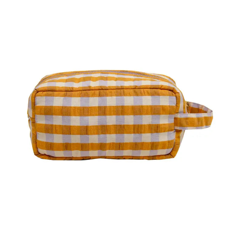 Orange and purple checkered toiletry bag on a white background