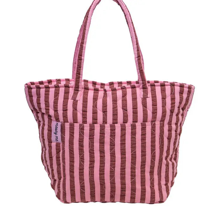 Pink and brown striped tote bag with 'mosey me' label on a white background