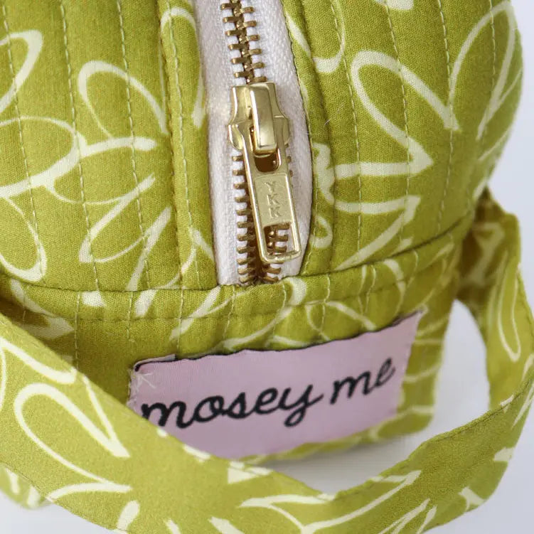 Green patterned bag with a gold zipper and &