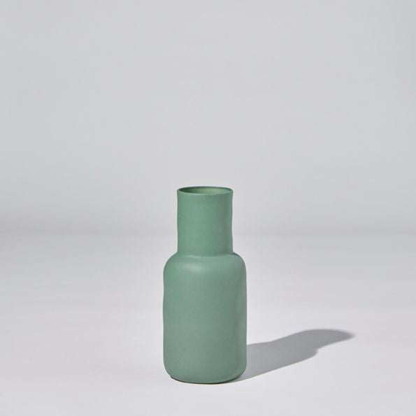 Green vase on a light gray background