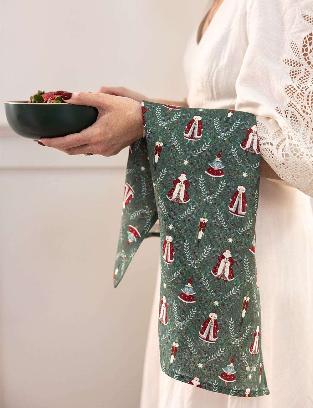 Christmas linen tea towel with santa claus over someones arm