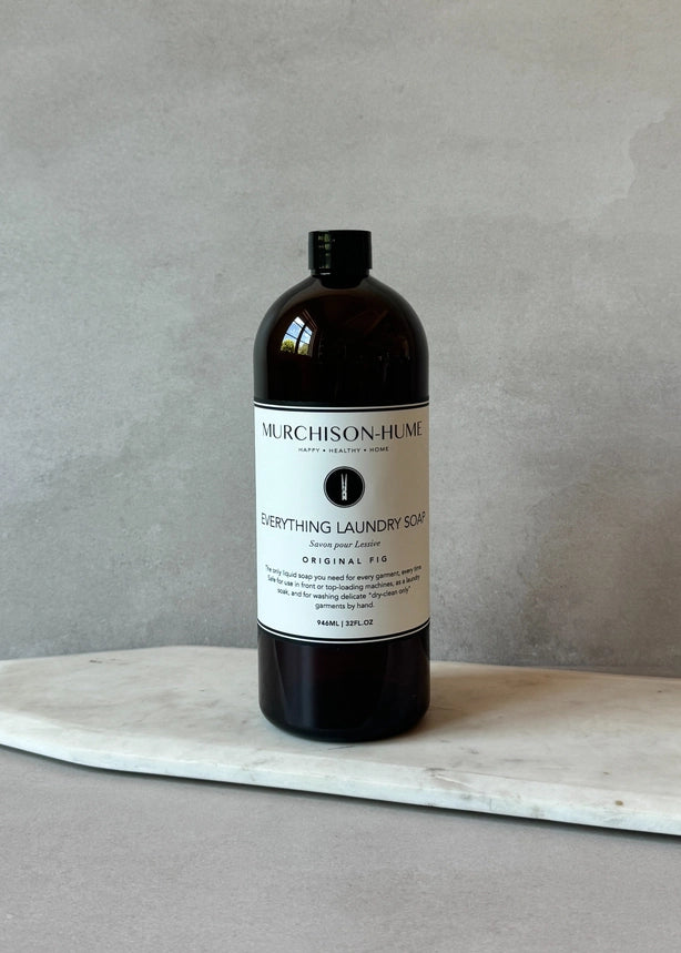 Bottle of Murchison- Hume laundry soap on a marble surface with a gray background