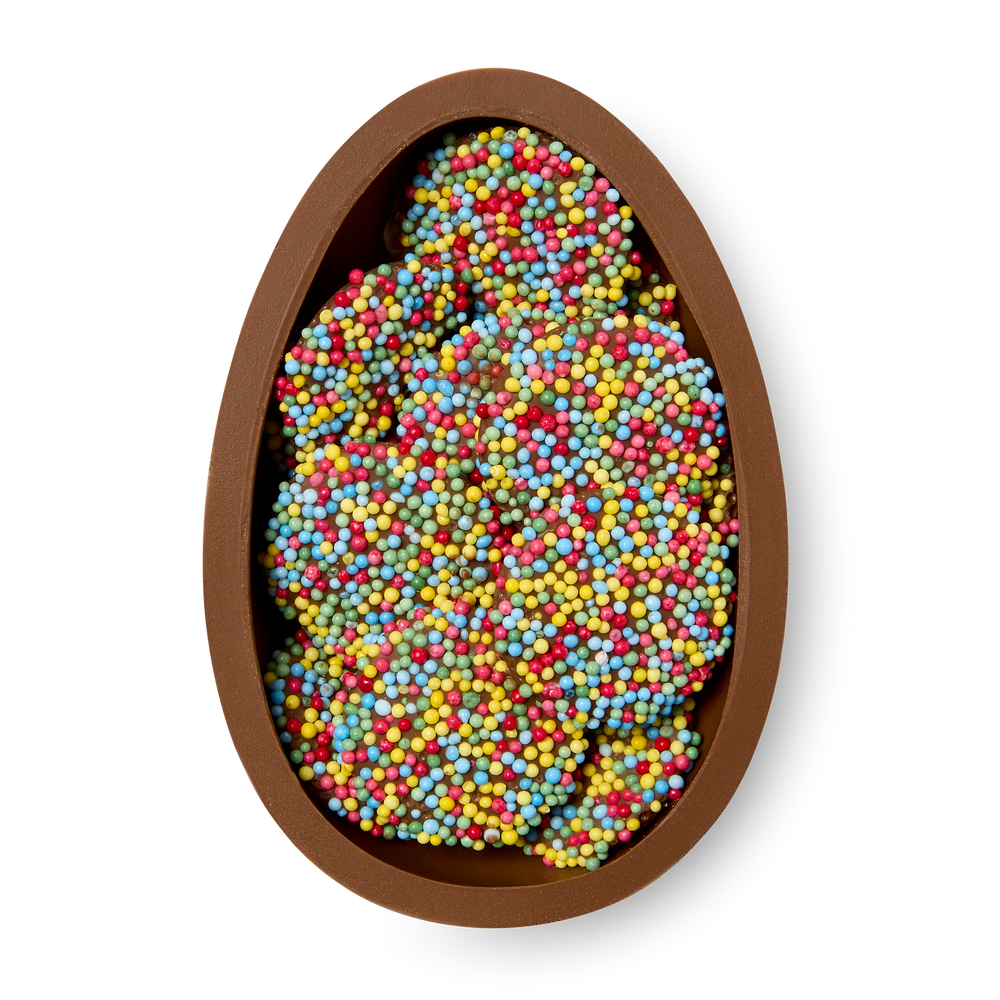 Egg-shaped container filled with colourful chocolate freckles on a white background
