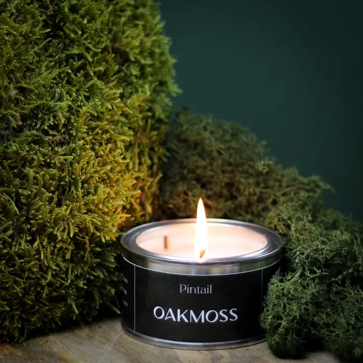 Candle in a tin labeled &