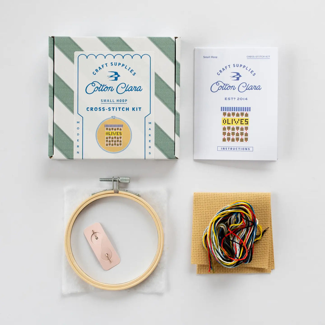 Cotton Clara cross-stitch kit with hoop, thread, and instructions on a white background