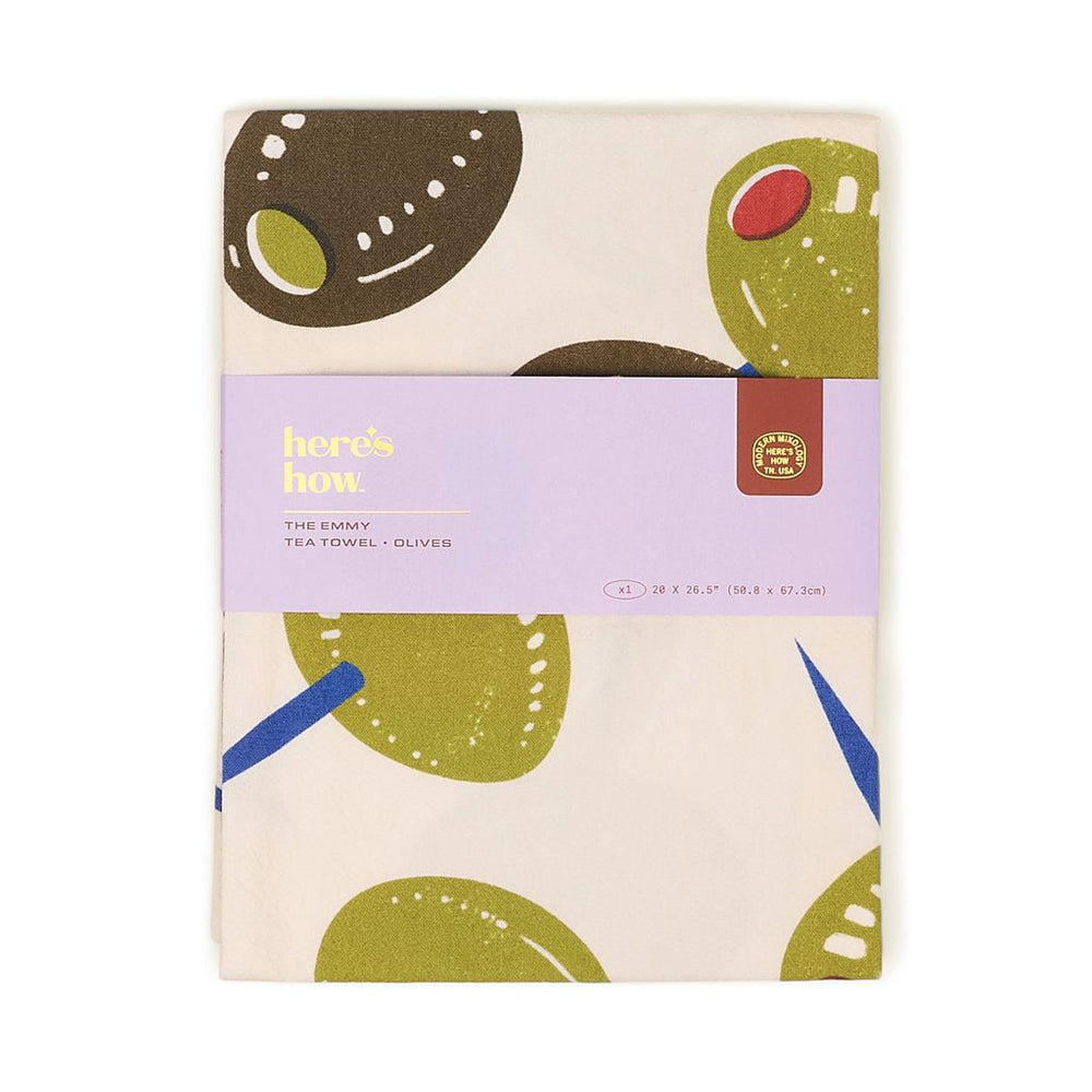 Tea towel with olive design and 'here's bow' branding on a white background