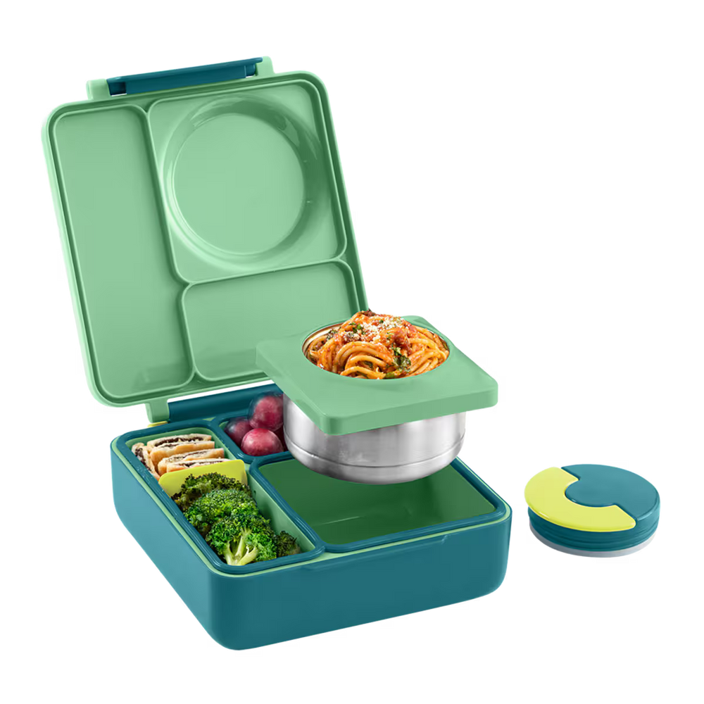 Green and teal bento box with compartments containing food on a white background