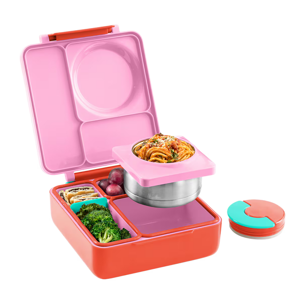 Pink and orange bento box with compartments filled with food on a white background