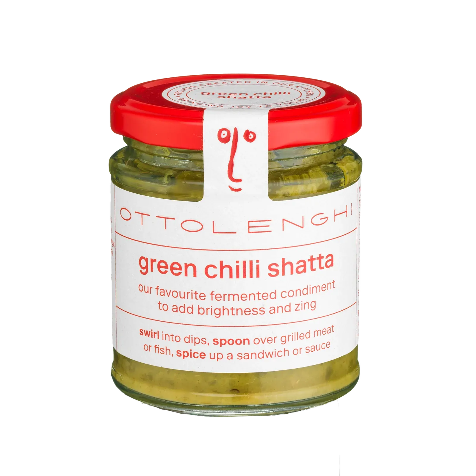 A glass jar of Ottolenghi Green Chilli Shatta condiment, featuring a white label with red text and a red lid, set against a plain white background.