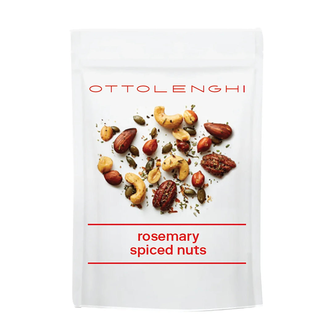 A white stand-up pouch of Ottolenghi Rosemary Spiced Nuts, featuring a photo of mixed nuts in the center with red text.