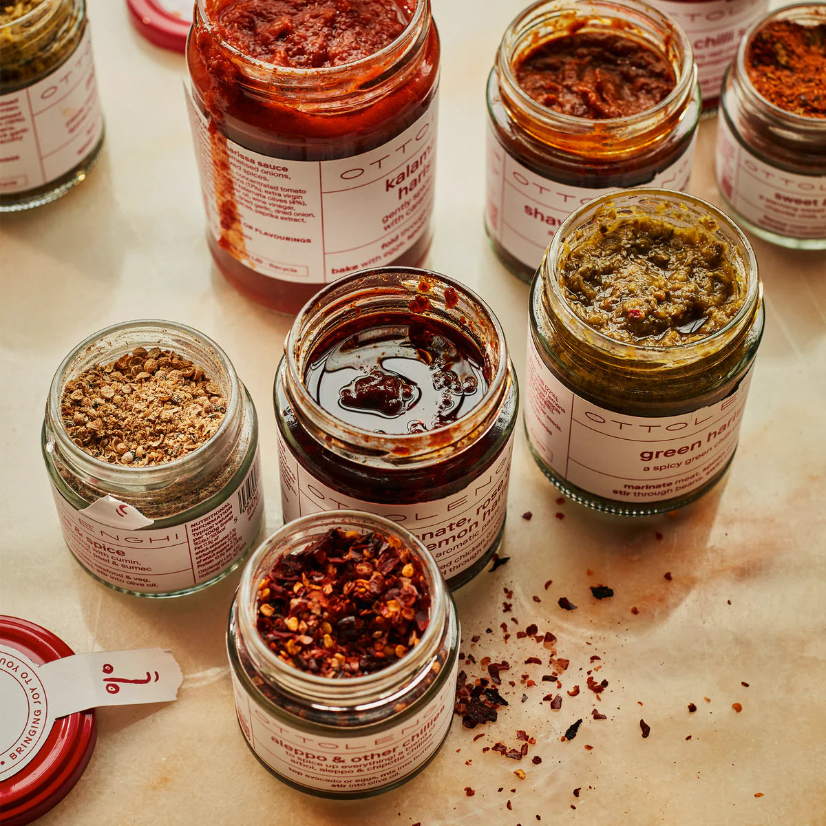 A range of Ottolenghi food products with lids off