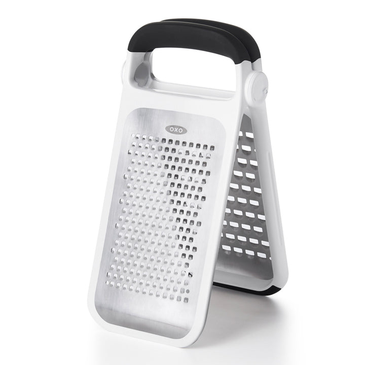 White box grater with black handle on a white background