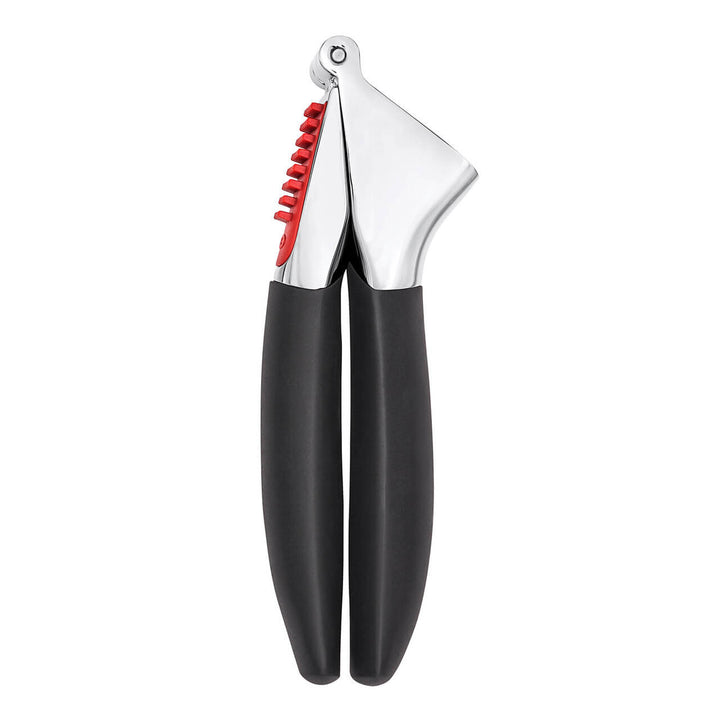 Garlic press with black handles and red interior on a white background