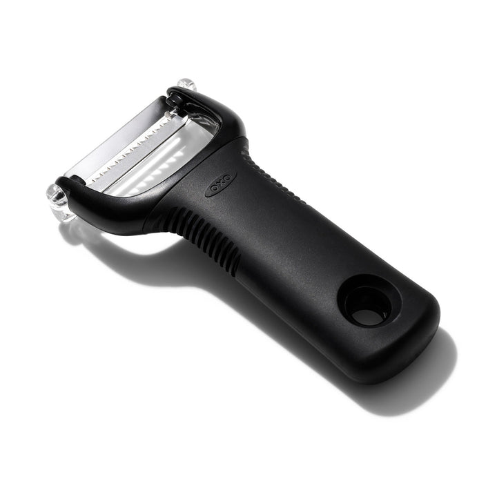Black vegetable peeler on a white background