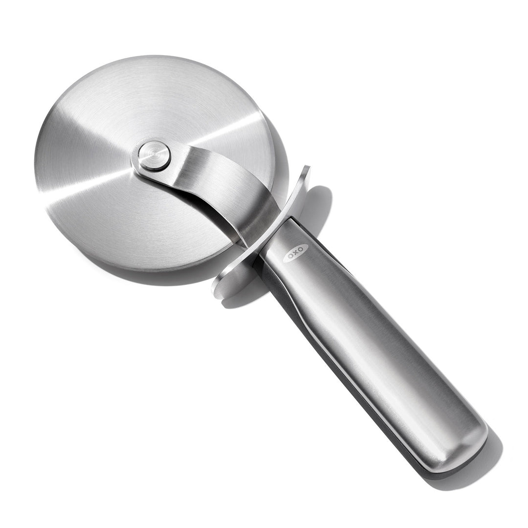 Stainless steel pizza cutter on a white background