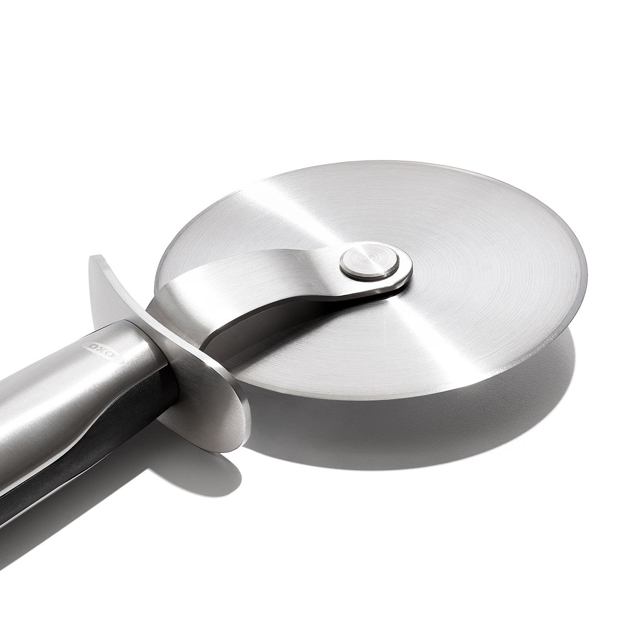Stainless steel pizza cutter on a white background