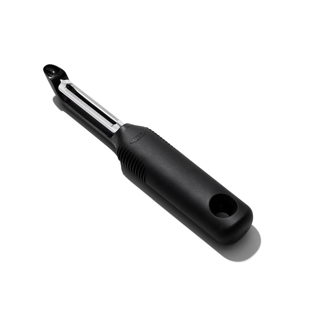 Black vegetable peeler on a white background