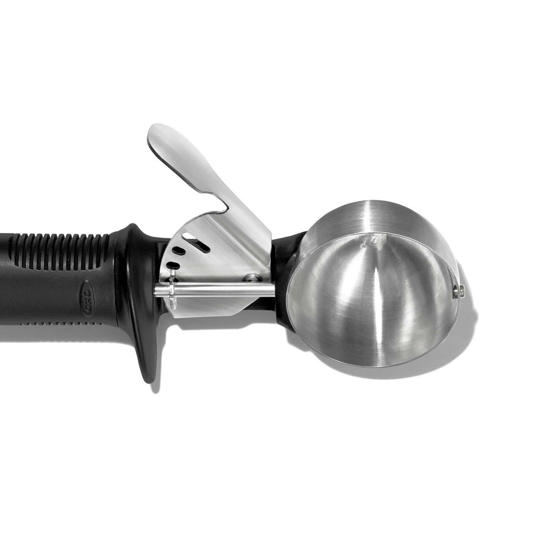 Metallic ice cream scoop on a white background