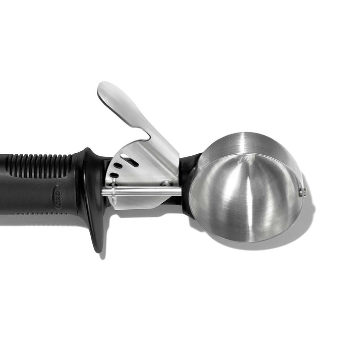 Metallic ice cream scoop on a white background