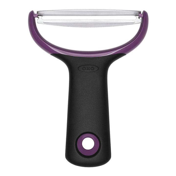 Oxo vegetable peeler with purple handle and blade on a white background