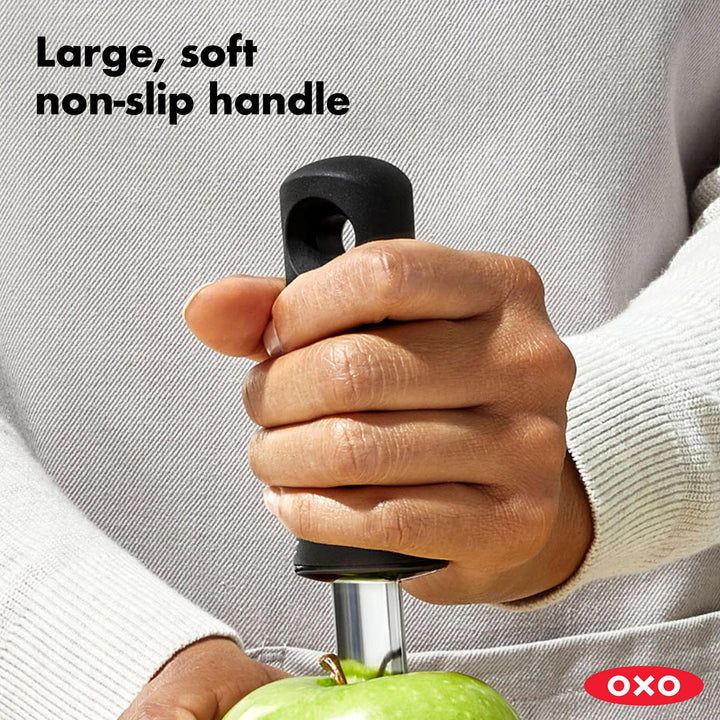 Hand holding a kitchen tool with a large, soft non-slip handle, branded OXO.