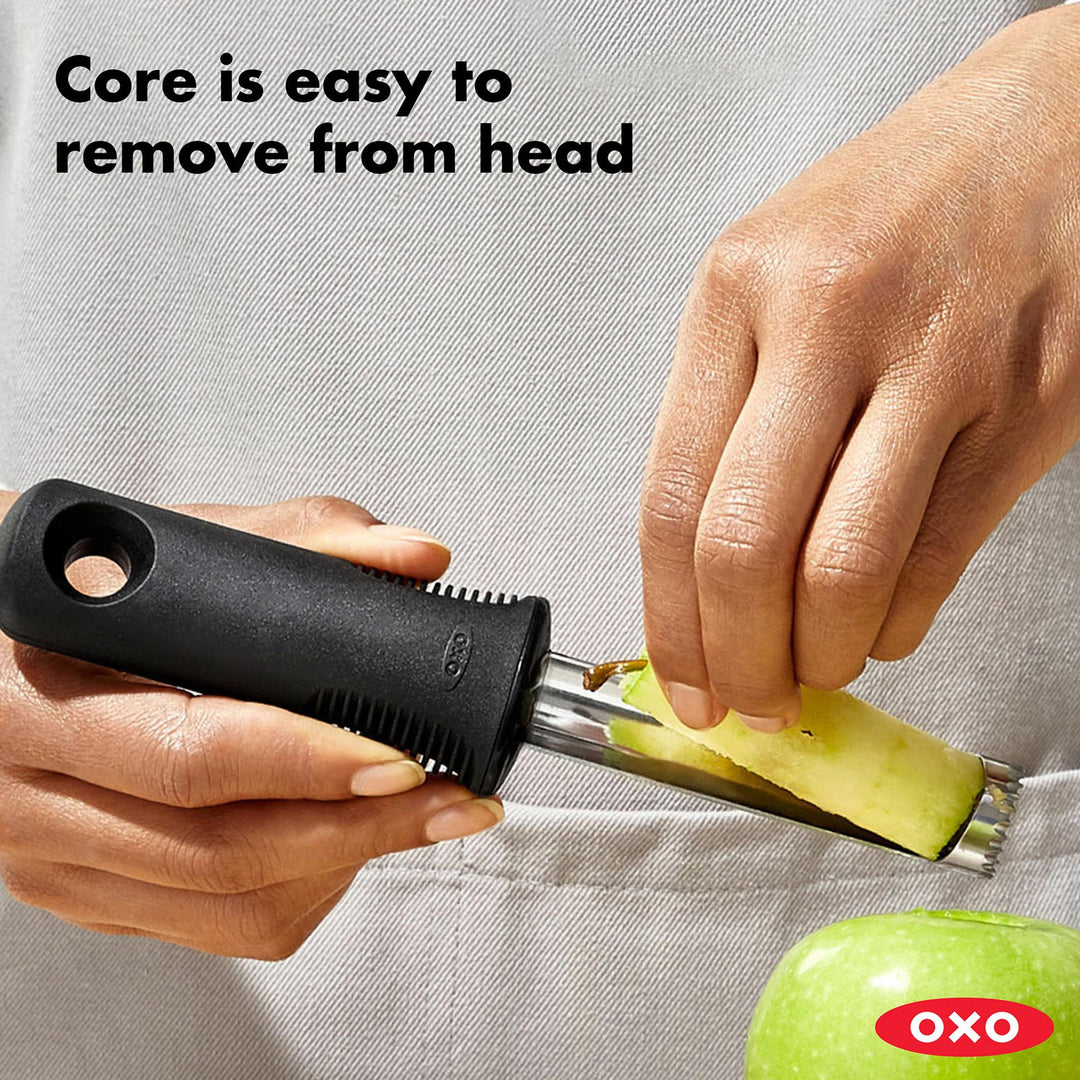 OXO apple corer being used on a green apple with text &