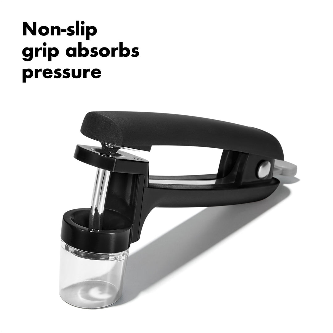 Black kitchen tool with non-slip grip and pressure absorption feature on a white background
