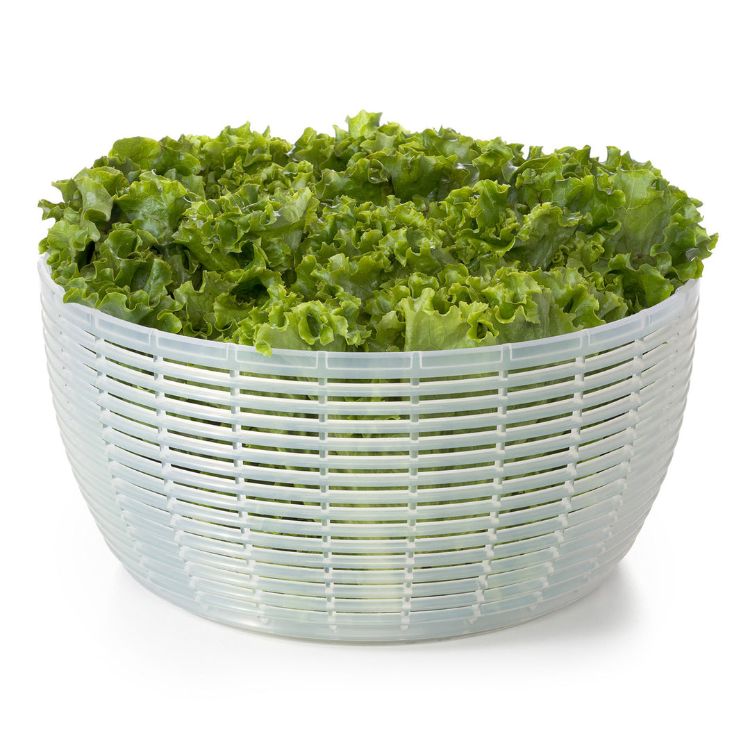 Salad spinner with green lettuce on a white background