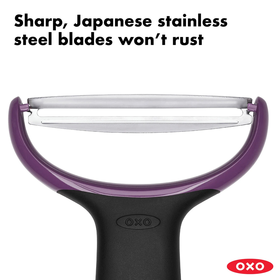 OXO vegetable peeler with purple handle and sharp blade on a white background