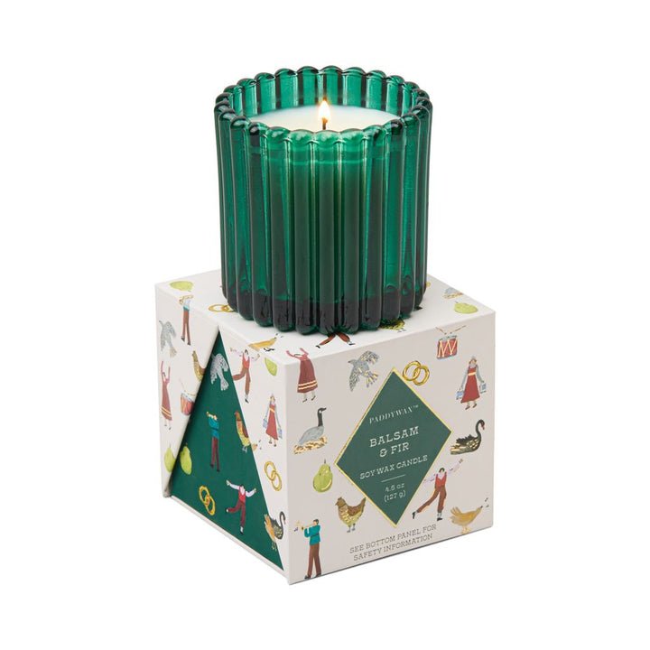 Green candle in a decorative box with illustrations on a white background