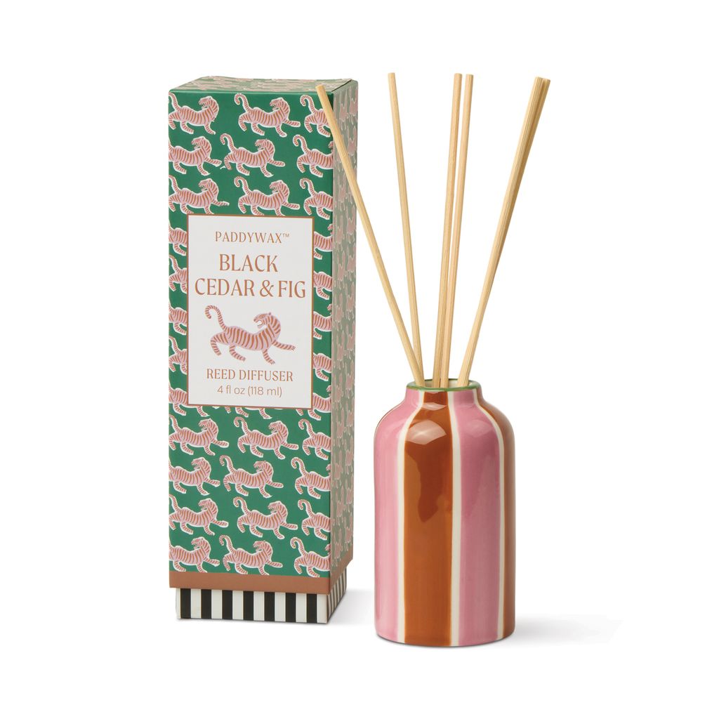 Fragrance diffuser with wooden sticks and decorative packaging on a white background
