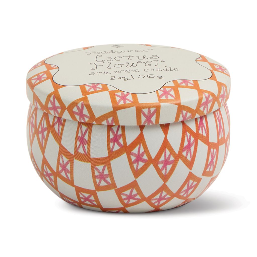 Decorative candle in a tin with geometric pattern on a white background