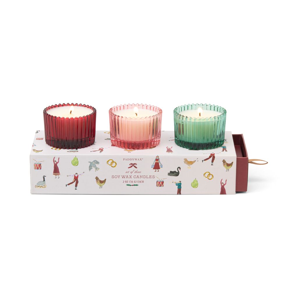 Three colorful candles in a decorative box with illustrations on a white background