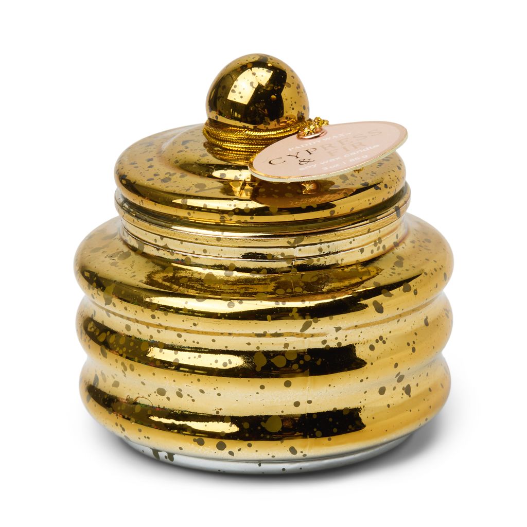 Gold decorative candle with a textured surface on a white background