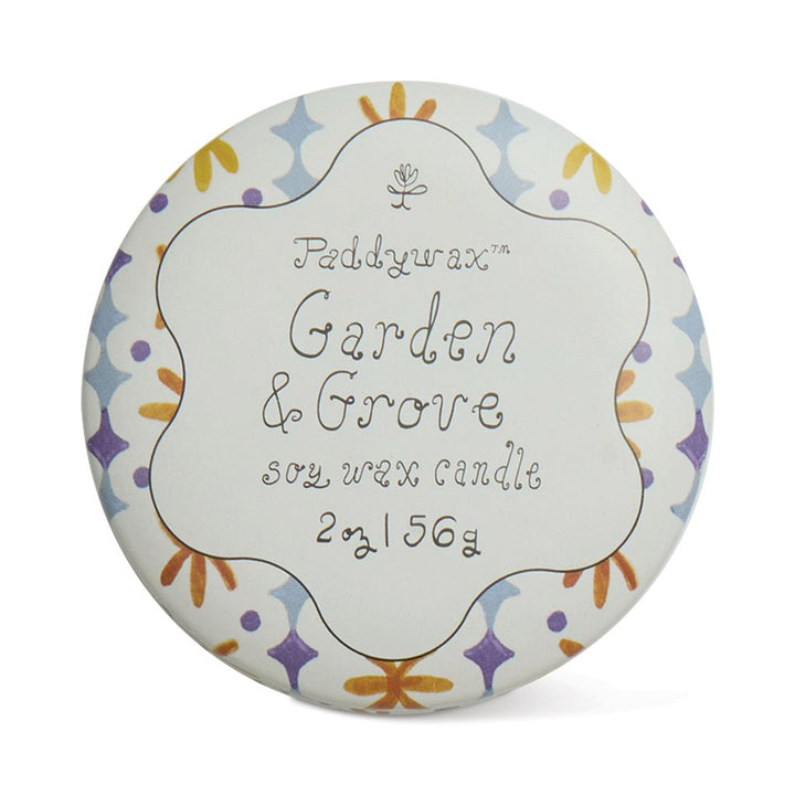 Paddywax Garden &amp; Grove candle packaging with decorative border on a white background