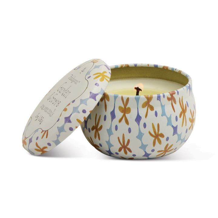 Decorative candle in a patterned container on a white background