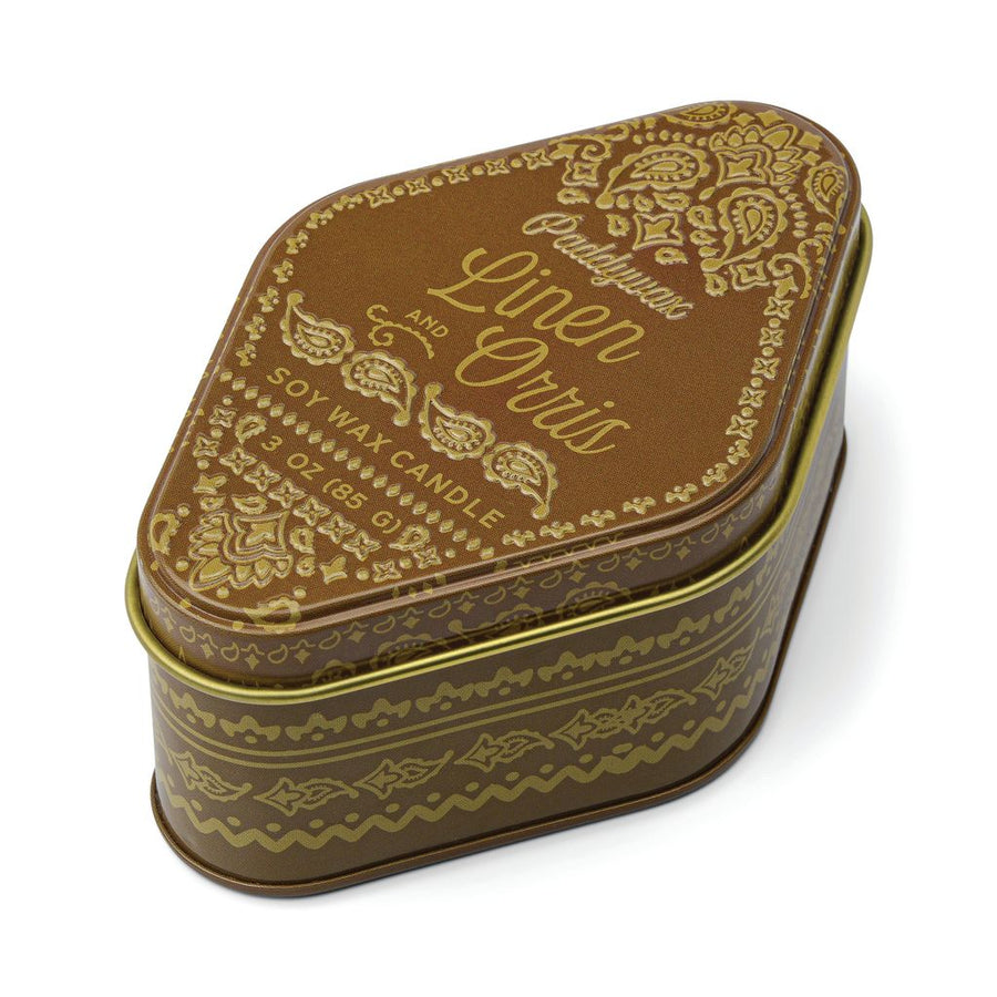 Candle in a brown tin on a white background