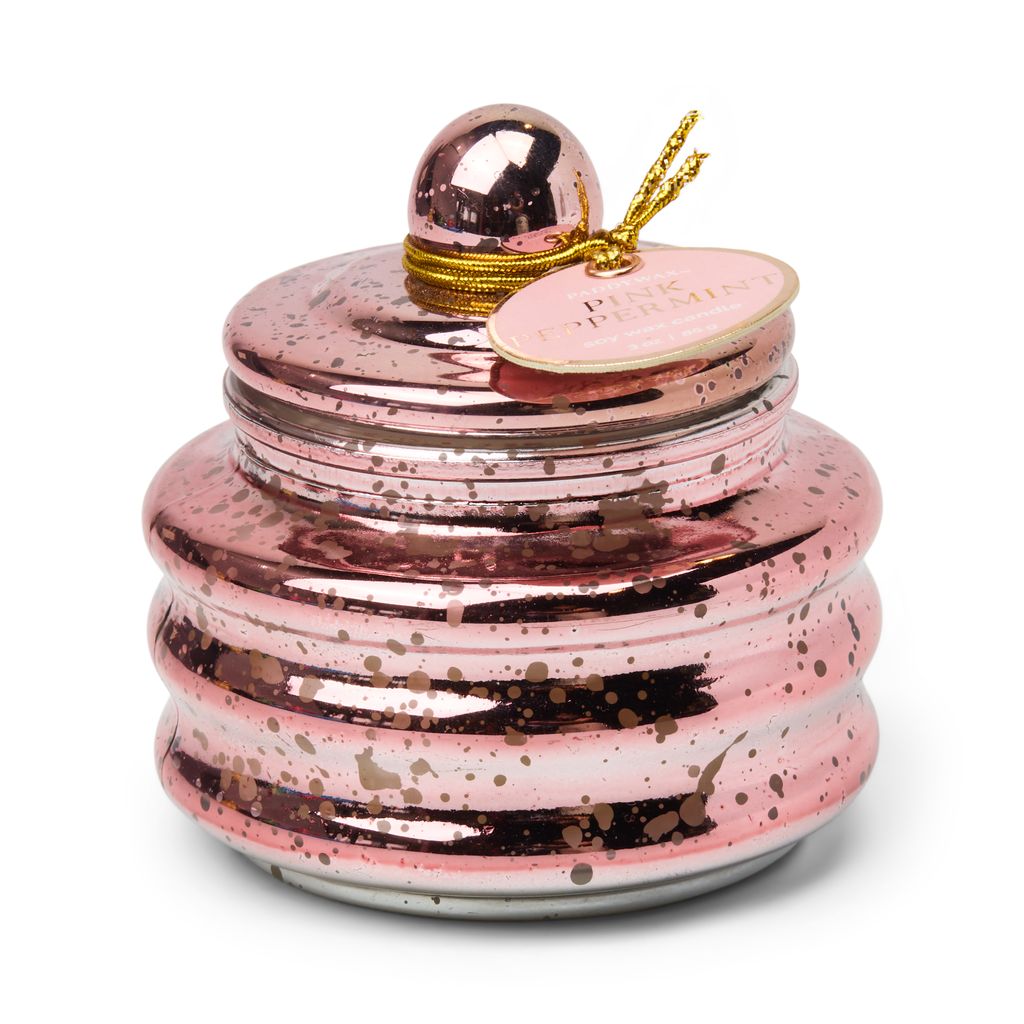 Pink metallic candle with gold accents on a white background