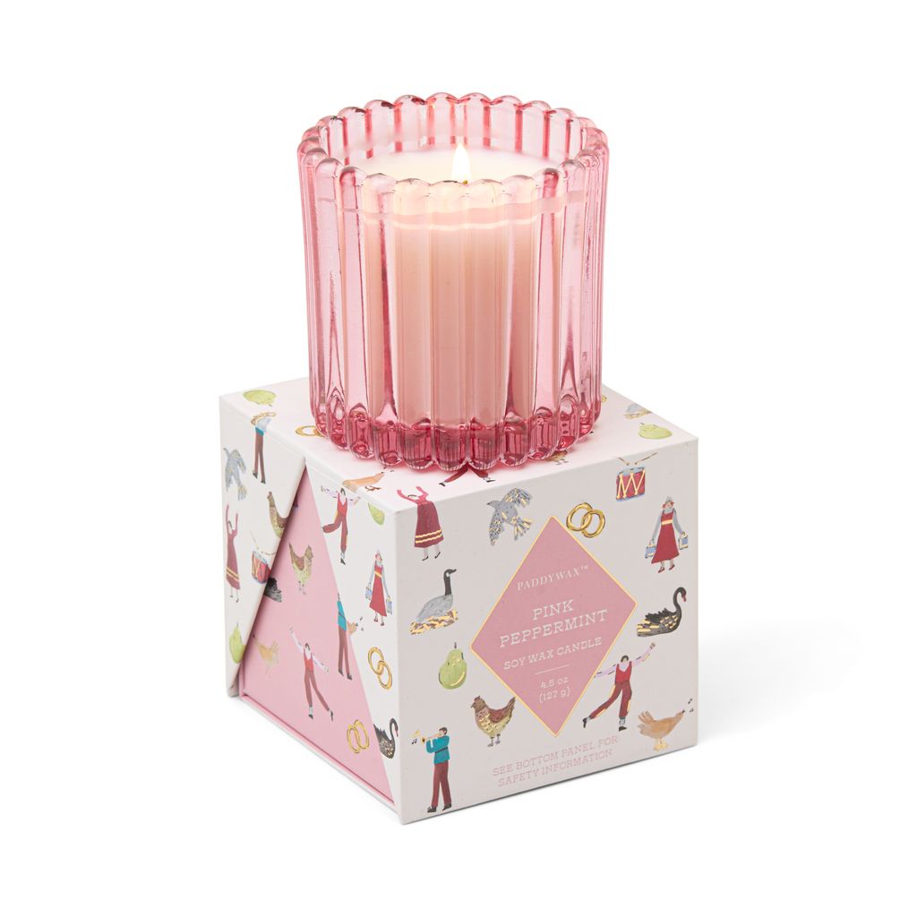 Pink candle in a decorative box with illustrations on a white background