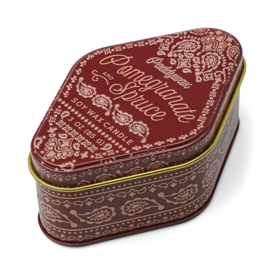 Decorative candle tin with paisley pattern and text on a white background