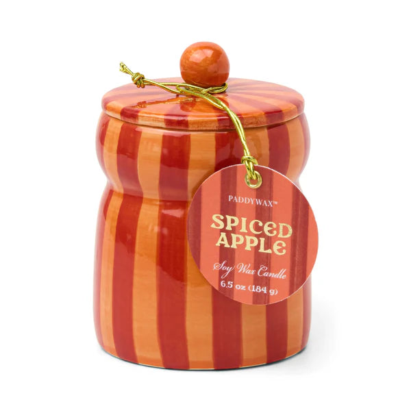 Candle jar with striped design and 'Spiced Apple' label on a white background