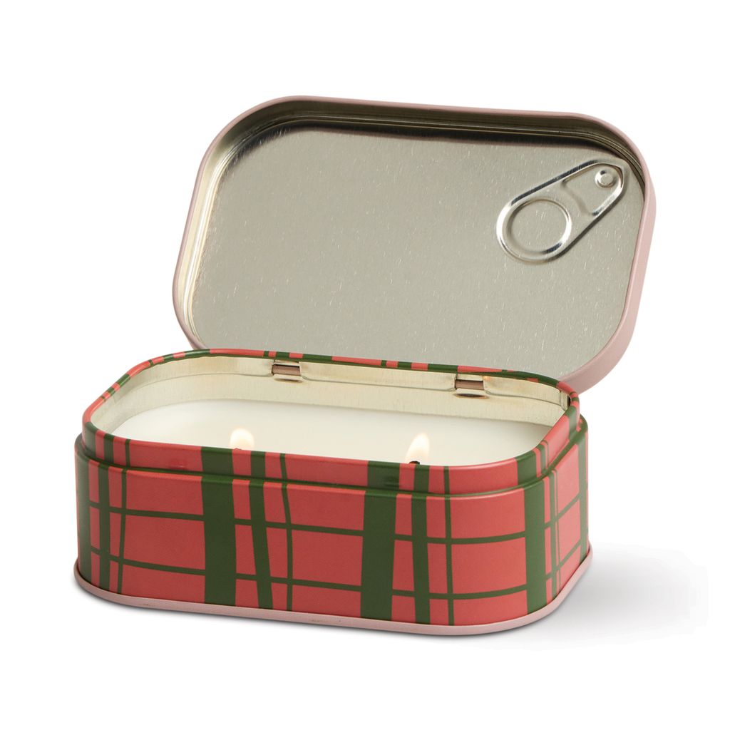 Red and green plaid candle in a tin with a lid on a white background