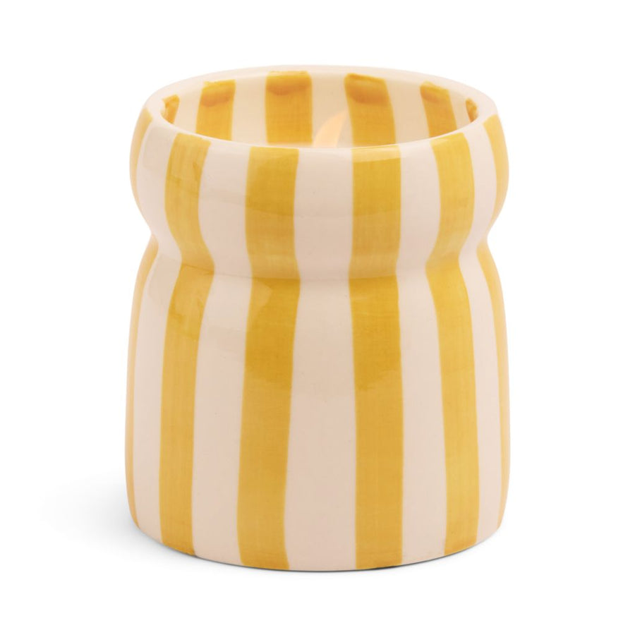Cylindrical ceramic candle with yellow and white vertical stripes on a white background
