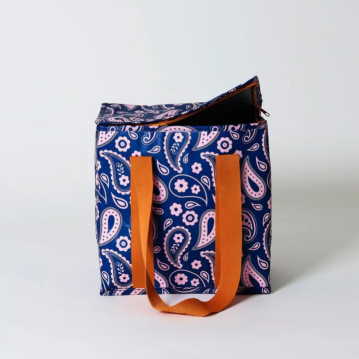 Blue paisley patterned bag with orange handles on a white background