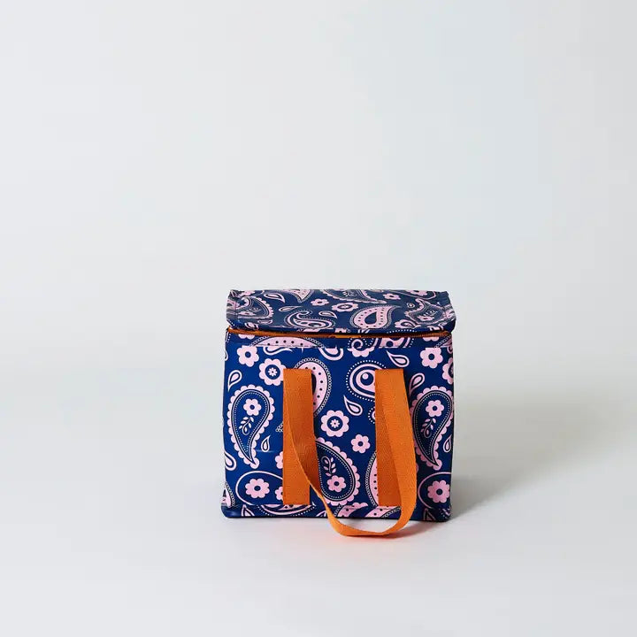 Navy blue cooler bag with pink floral paisley pattern and orange handles on a white background