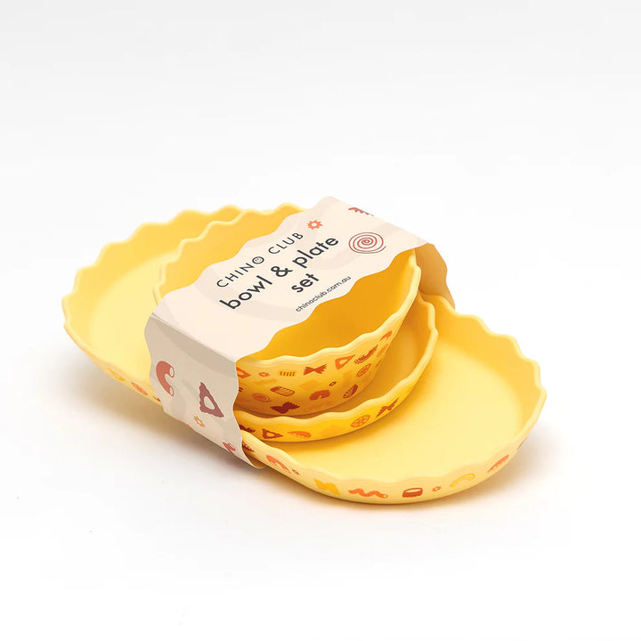 Set of yellow bowls with a packaging label on a white background