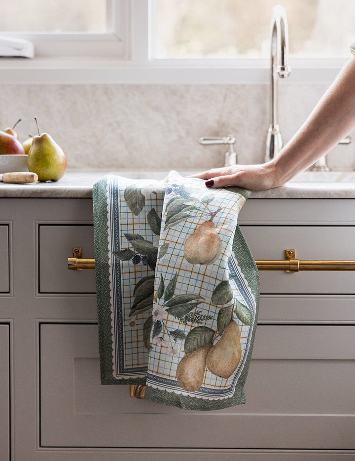 Kitchen towel with pear design hanging on a cabinet handle